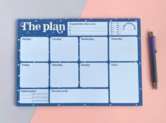 a blue and white calendar with the word the plan on it next to a pen