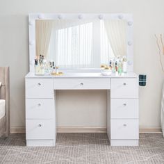 a white vanity with lights on it in a bedroom next to a bed and window