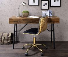 a desk with a chair and pictures on the wall above it in a home office