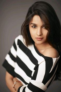 a woman in striped shirt posing for the camera