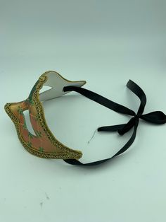 "This is a very nice original handmade and hand painted Venezia masquerade face mask made in Italy. The design on the shiny gold and orange face mask features turquoise blue and multi-color glitter with a border of gold lace and gold rope around the edges. It comes with a black ribbon tie and is stamped on the back \"Original Hand Painted Made in Italy Venezia\". The mask measures approximately 6 5/8\" long and 3 3/4\" wide and is in very good preowned condition with light wear on the back of th Adjustable Masks And Prosthetics For Carnival And Halloween, Adjustable Masks And Prosthetics For Halloween Carnival, Adjustable Masquerade Mask For Mardi Gras, Adjustable Masquerade Mask For Costume Party, Adjustable Masquerade Mask Costume Accessories, Multicolor Masks And Prosthetics For Masquerade And Carnival, Green Masquerade Mask For Mardi Gras, Multicolor Masks And Prosthetics For Carnival Masquerade, Adjustable Masks For Carnival Costume Party