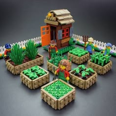 there are many legos in the garden and one has a small house on it