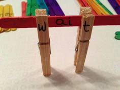 two wooden pegs with words written on them are standing in front of each other