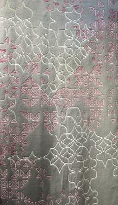 a piece of cloth with pink and white designs on it