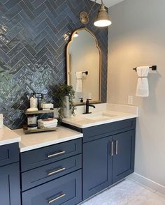 a bathroom with two sinks and a large mirror on the wall next to each other