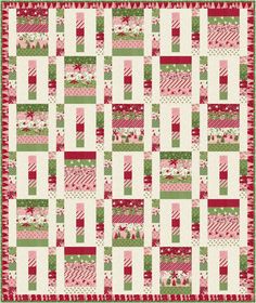 a quilt with red, green and white squares on it's sides in the shape of christmas trees