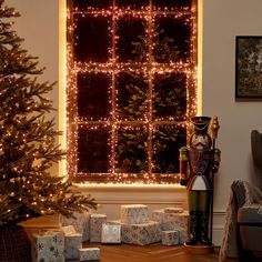 a christmas tree and presents in front of a window