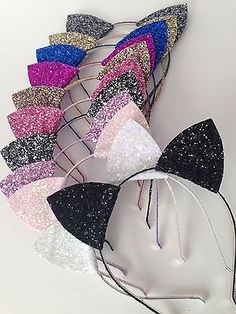 there are many different colored bows on the headbands and one is black, white, pink, blue