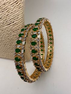 American Diamonds Baguettes Emerald Green Stone Diamond Finish Floral Pattern Bangles Please measure your size before ordering as we don't accept returns. Starting size we have is 2.4. We don't carry size 2.2. Any questions please let me know. thank You!! Ready to ship from Boston, Massachusetts. Emerald Bangles Indian, Green Stone Bangles, Emerald Bangles, Fashionable Saree, Emerald Green Stone, Jewelry Emerald, Indian Bangles, Fashionable Saree Blouse Designs, Bangles Indian