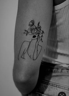 a woman's arm with a deer and flowers on it