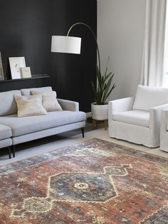 a living room with two couches and a rug