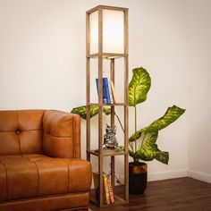 a living room with a brown leather couch and a tall wooden shelf filled with books