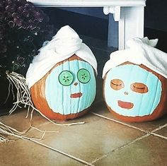 two pumpkins with faces painted on them