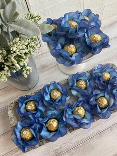 blue flowers and chocolates are arranged on a table