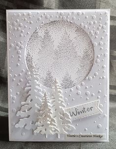 a white card with snow covered trees and the words winter written in black on it