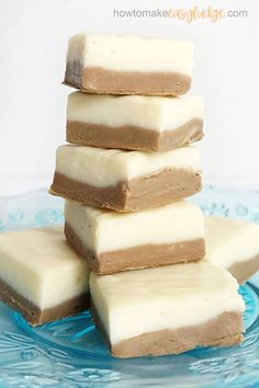 several pieces of chocolate and marshmallows stacked on top of each other in a blue glass plate