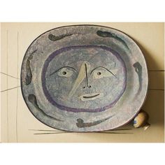 a ceramic plate with an image of a face on it