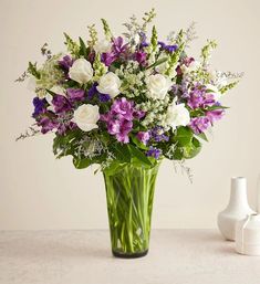 a vase filled with purple and white flowers