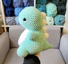 a crocheted stuffed animal sitting on top of a couch