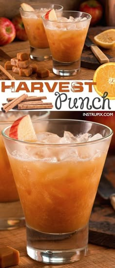 two glasses filled with orange punch on top of a wooden table next to apples and cinnamons