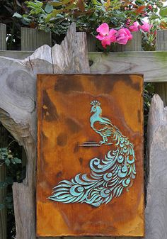 a wooden sign with a peacock painted on it