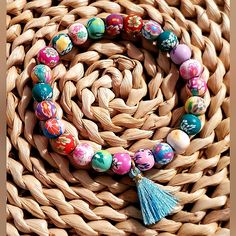 Handmade 8mm Polymer Clay Bead Flower Print Stretch Bracelet With Turquoise Tassel Charm. Made This Myself. It Is Stretch & Will Fit Average Size Wrist. If You Don't Like The Tassel I Will Gladly Take Off. Just Please Ask. This Is Brand New & Packaged. Colorful Adjustable Hand-strung Stretch Bracelet, Colorful Hand-strung Stretch Bracelet With Round Beads, Multicolor Hand-strung Bracelets With Oval Beads, Adjustable Multicolor Hand-strung Stretch Bracelet, Summer Multicolor Hand-strung Stretch Bracelet, Gold Heart Bracelet, Bead Flower, Silver Heart Bracelet, Blue Beaded Bracelets