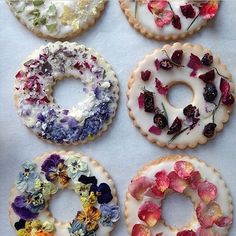 six different types of donuts with flowers on them