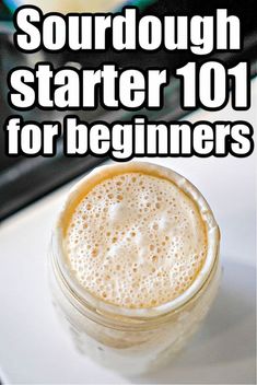 a close up of a drink on a table with the words sourdough starter 101 for beginners