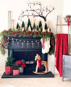 a fireplace decorated for christmas with stockings and garland on the mantel above it is a rocking horse