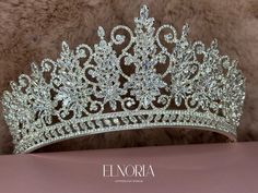 "Description Royal tiaras are the ones with marquise-shaped stones that symbolize royalty and nobility. The combination of the marquise stones and the popular round-shaped stones makes the bridal wedding crown breathtaking. Add more to the brightness of your white dress with the clear-stone color and the silver-plated crown. *SIZE: Approximately 7 cm wide in the middle. *MATERIALS: Clear cubic zirconia stones, silver-plated crown *STONES COLOR: Clear. *PREPARATION & SHIPPING: - Normal preparatio Elegant Silver Crown-shaped Jewelry, Luxury Crown-shaped Elegant Jewelry, Silver Fantasy Crown-shaped Jewelry, Boho Wedding Crown, Silver Wedding Crown With Rhinestones, Elegant Silver Crown With Rhinestones, Bridal Crown Tiara, Crown Aesthetic, Bridal Floral Headpiece