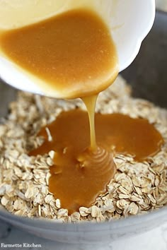 someone pouring peanut butter on oatmeal in a bowl