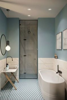 a bathroom with blue walls and flooring, including a white bathtub next to a walk in shower