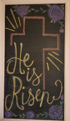 a chalkboard with the words he is risen written in gold and purple on it