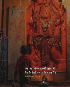 there is a man standing in front of a statue with words written on the side