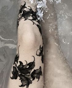 a woman's foot with black flowers on it