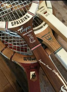 several wooden tennis rackets are stacked on top of each other