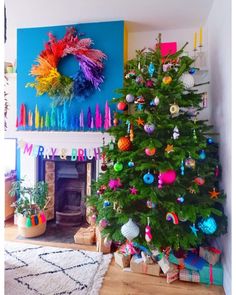 a dog laying on the floor in front of a christmas tree with decorations around it