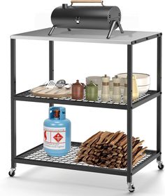 an outdoor bbq is shown with wood on the bottom shelf and a blue bottle