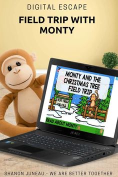 a stuffed monkey sitting on top of a laptop computer