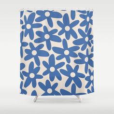 a blue and white shower curtain with flowers on it