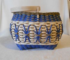 a blue and white basket sitting on top of a table