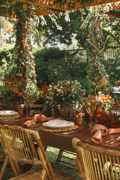 the table is set with plates and place settings