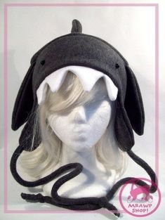 a mannequin head wearing a black and white shark hat