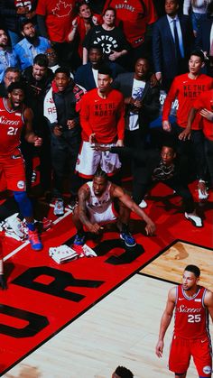 a group of men standing on top of a basketball court