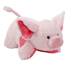 a pink pig stuffed animal laying on its side