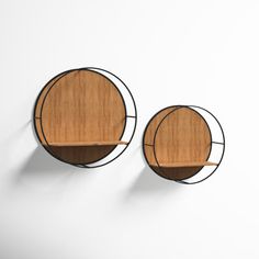 two circular wooden shelves mounted to the side of a wall