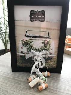 an old car is decorated with greenery and bows for the wedding guests to take home