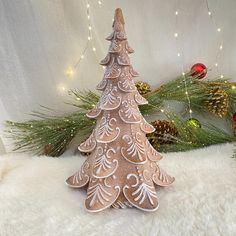 a christmas tree made out of cookies sitting on top of a white fur covered floor