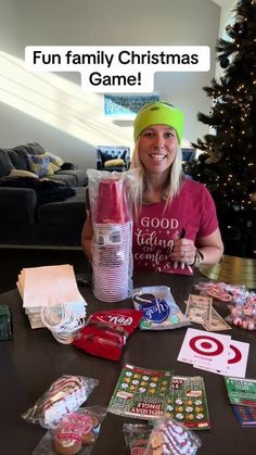 a woman sitting at a table with lots of items on it and the caption fun family christmas game