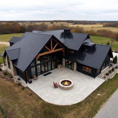 an aerial view of a large house with a fire pit in the middle of it